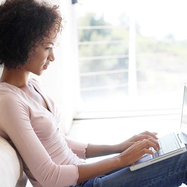 Woman works on her laptop at home.